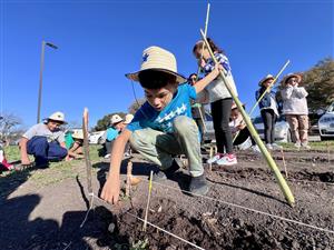 student planting seeds